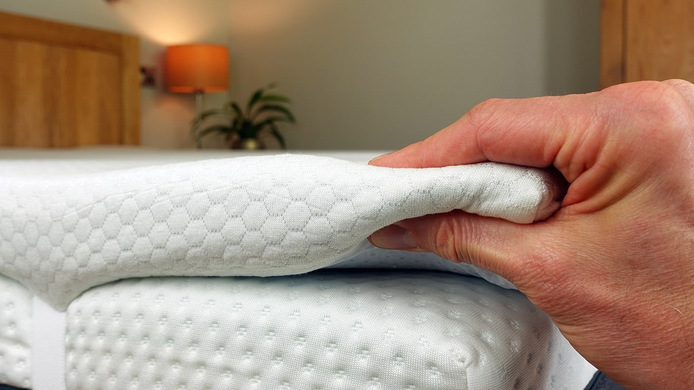 close up photo of a hand compressing the Panda mattress topper