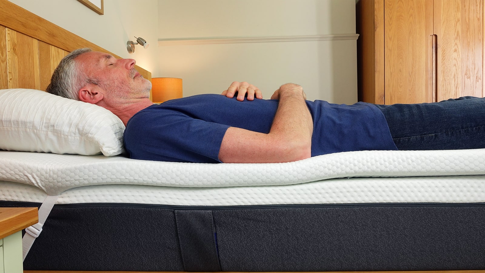 man lying on the Panda mattress topper