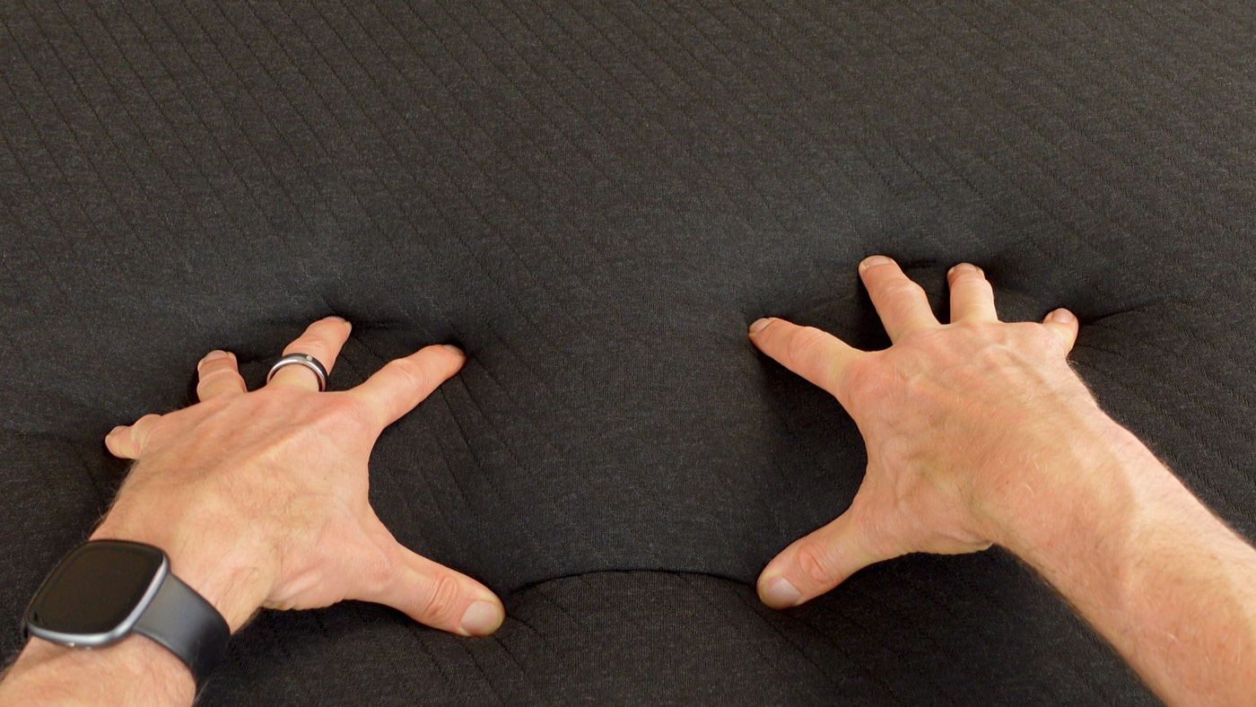 hands pressing into the eight sleep pod 5 mattress pad