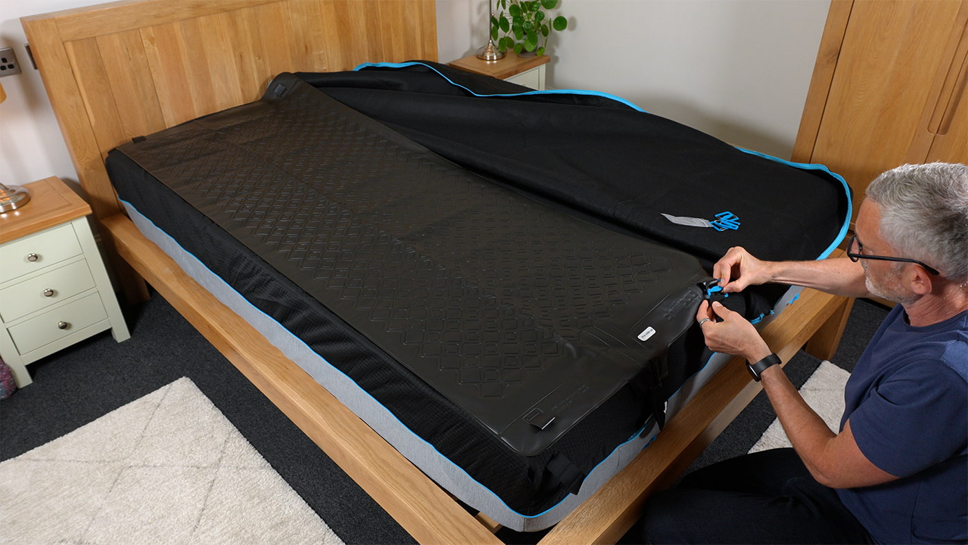 man installing the hydrolayer section of the Chilipad 2.0