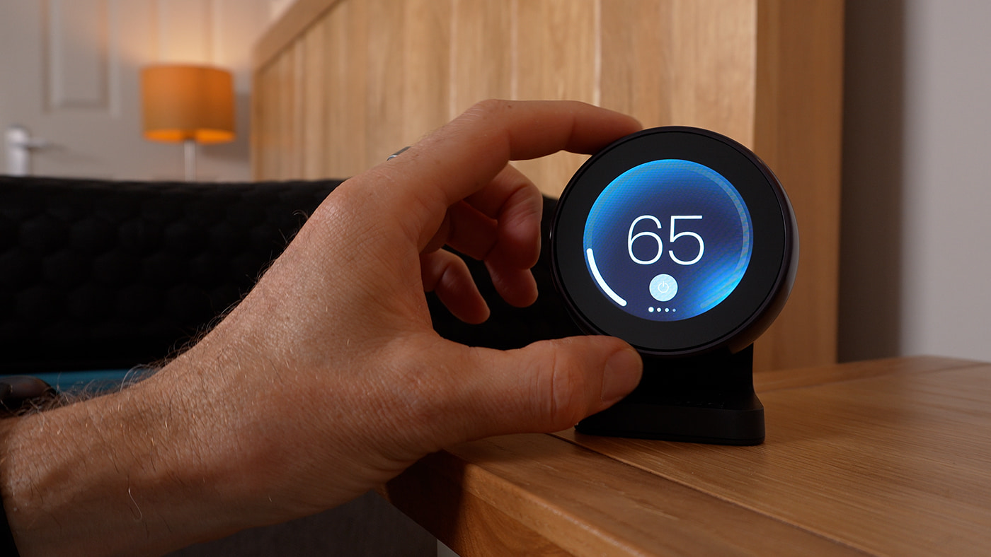 Chilipad 2.0 on a bedside table showing 65 degrees Fahrenheit