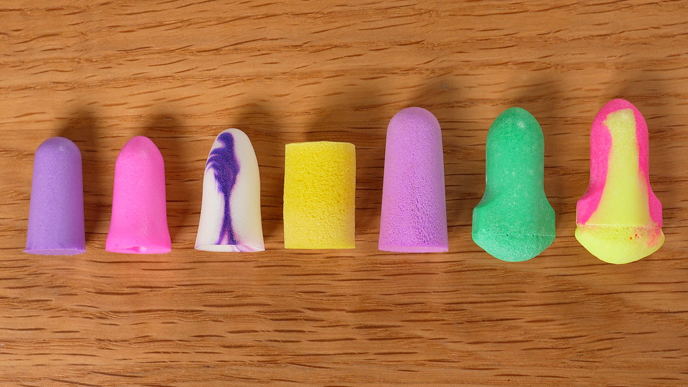 7 earplugs in a line: Mack's Slim Fit, Mack's Dream Girl, Moldex Spark Plugs, 3M Comfort, Flents Quiet Time, Howard Leight Max Lite, Howard Leight Laser Lite.